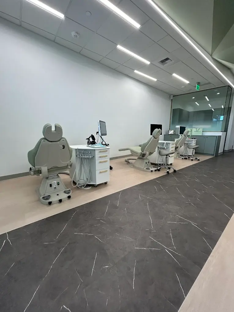 Dental chairs and equipment are lined up in the well-lit clinic of Emerald City Orthodontics in Kirkland, WA.