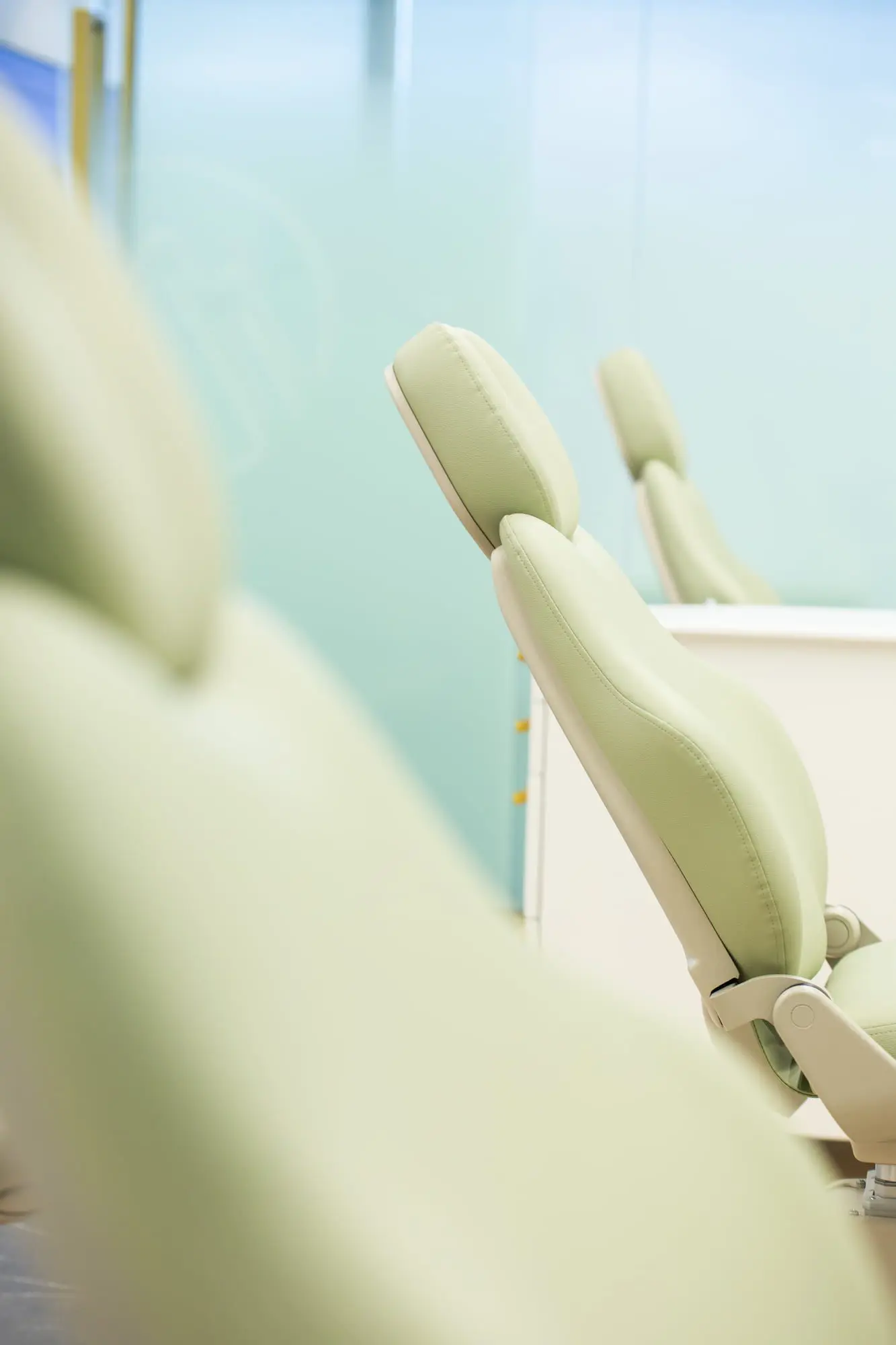 A modern, light green dental chair inside Emerald City Orthodontics' bright clinic in Kirkland, WA.
