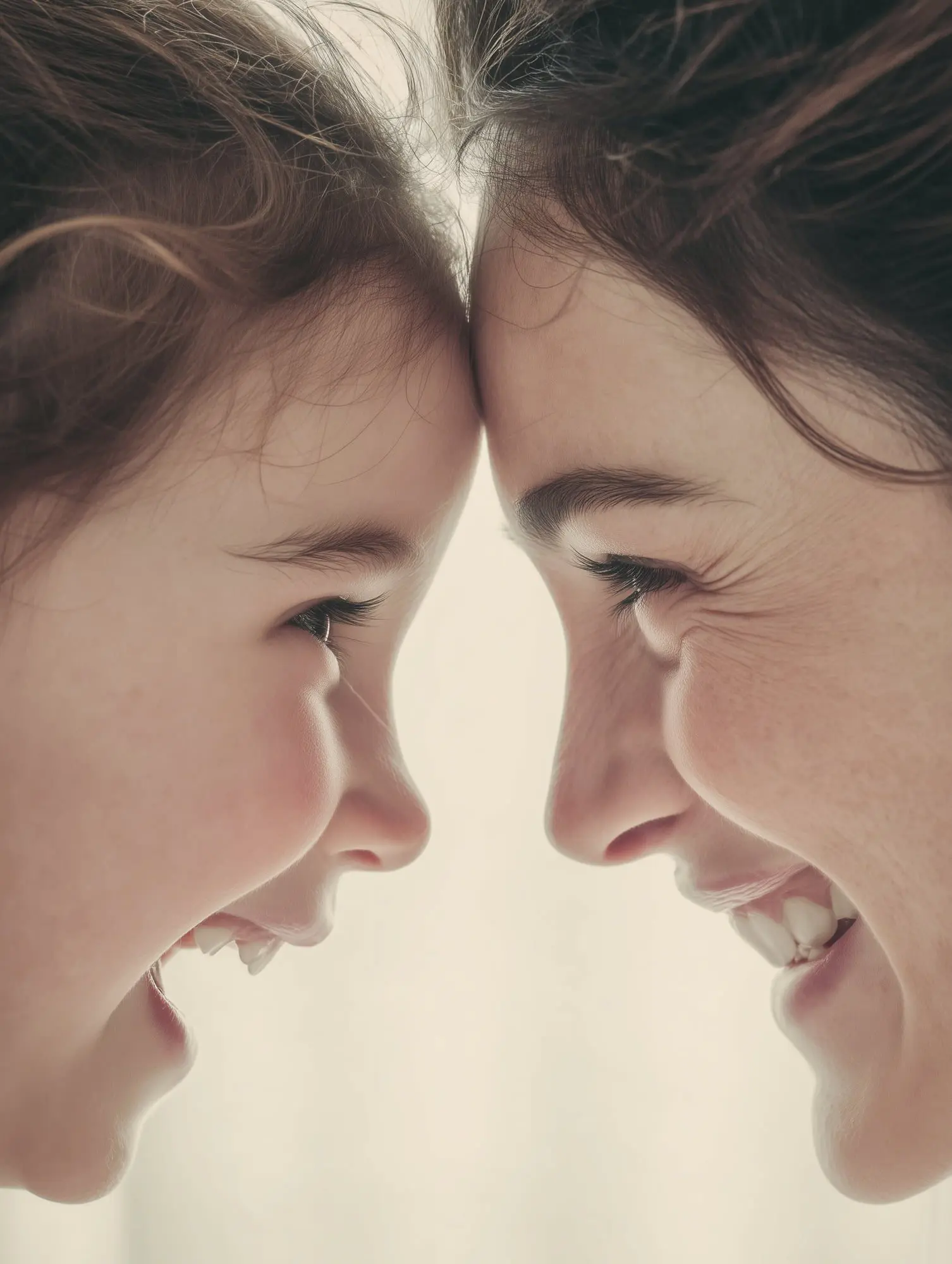 A child shows orthodontic appliances in a happy grin at Emerald City Orthodontics in Kirkland, WA, smiling with an adult.