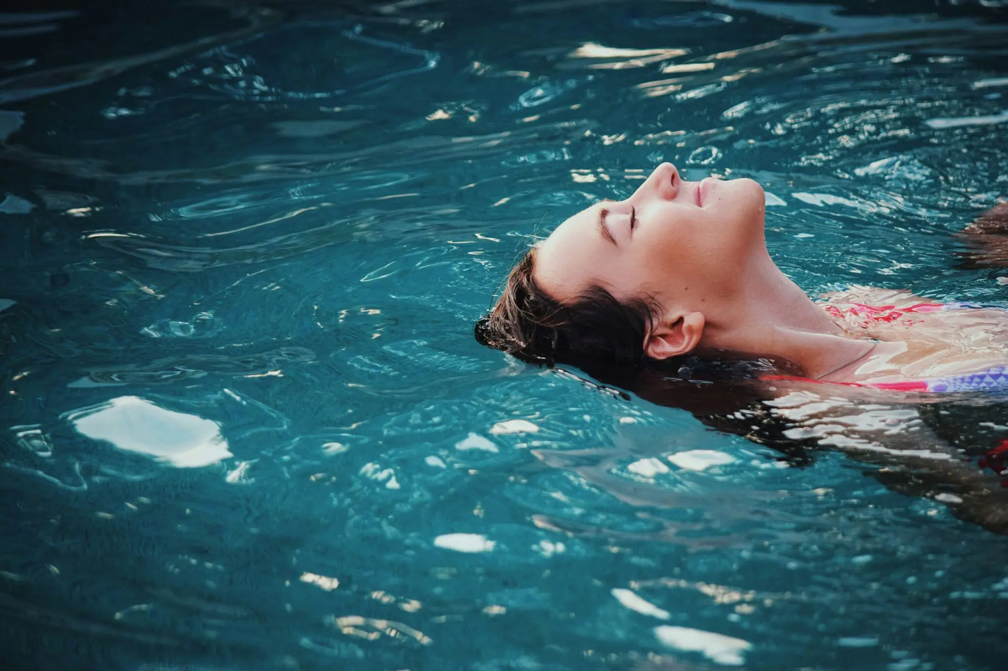 In a pool in Kirkland, WA, a person floats calmly—Emerald City Orthodontics highlights mindful breathing’s health impact.
