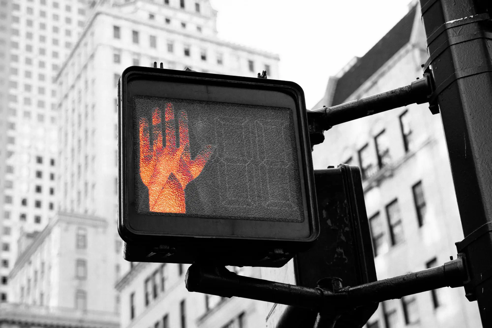 A red pedestrian signal shows a stop hand, city buildings, and an Emerald City Orthodontics ad in Kirkland, WA.