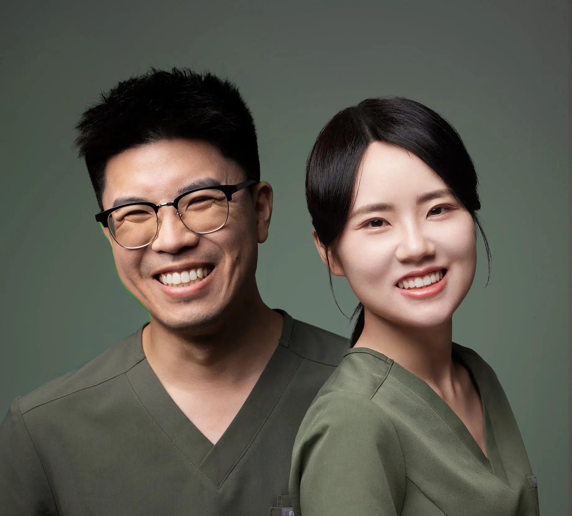 Smiling healthcare professionals in green scrubs at Emerald City Orthodontics in Kirkland WA, ready to discuss Invisalign insurance.